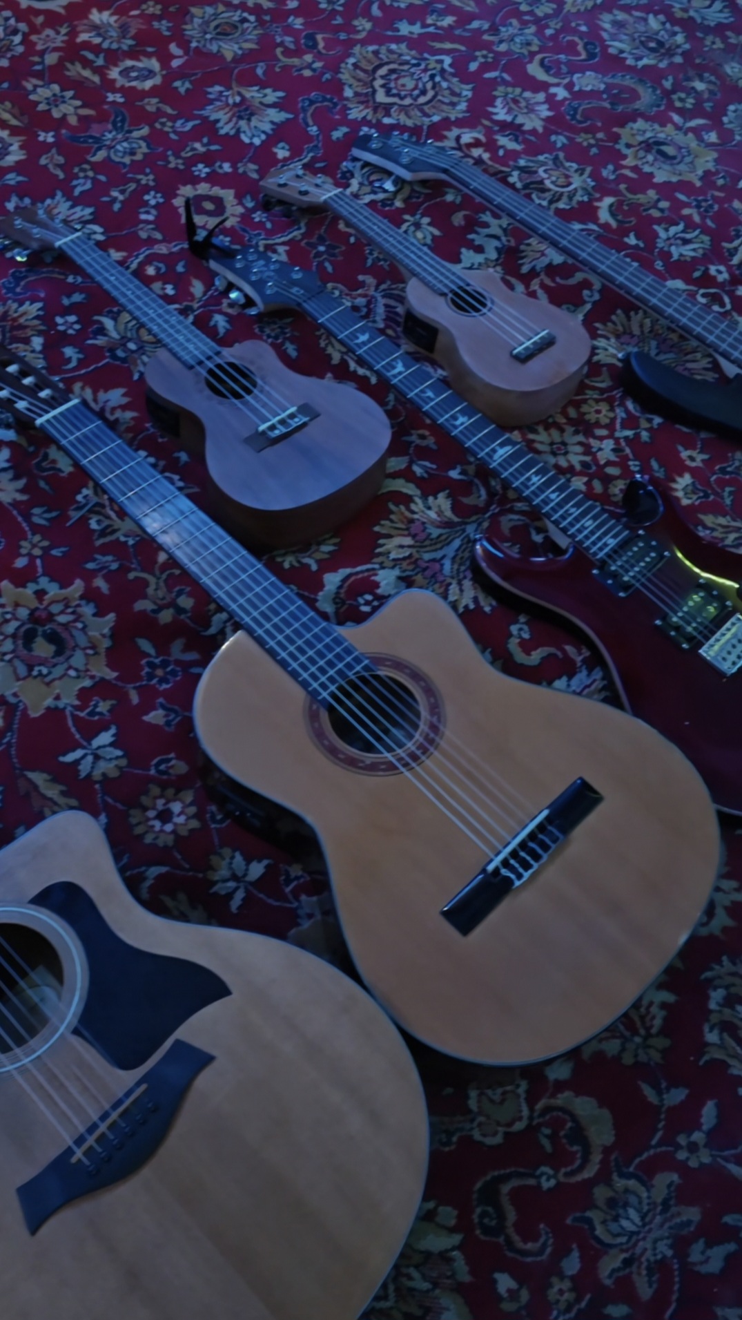 Guitars arranged on a studio rug